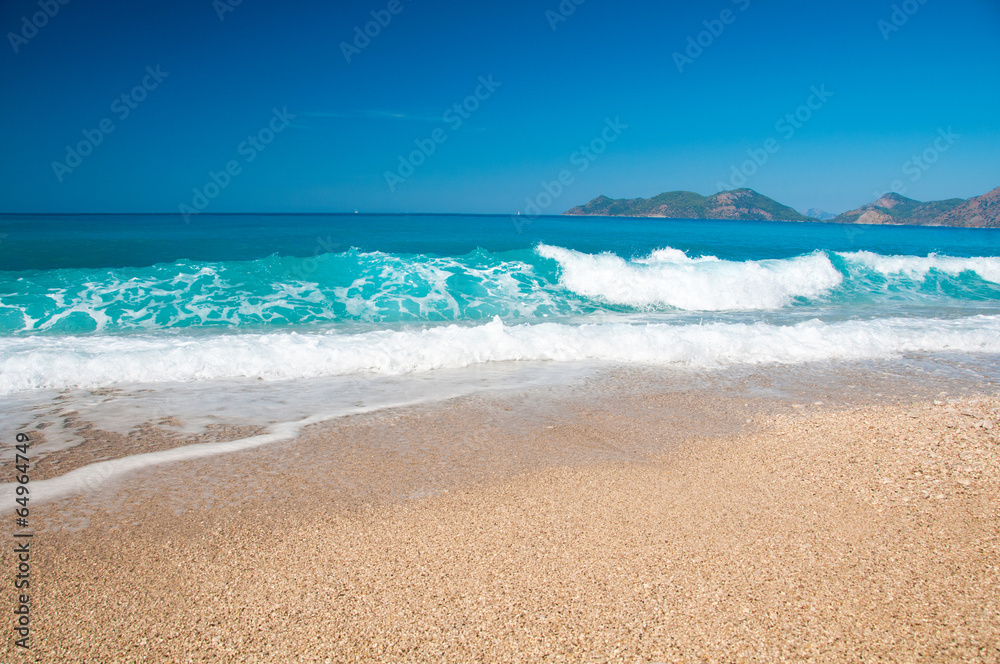 Beautiful surf on the beach. Mountains on the horizon. Beautiful surf on the beach. Mountains on the horizon.