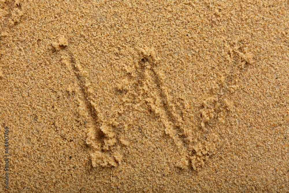 Alphabet letter written on wet beach sand Alphabet letter written on wet beach sand