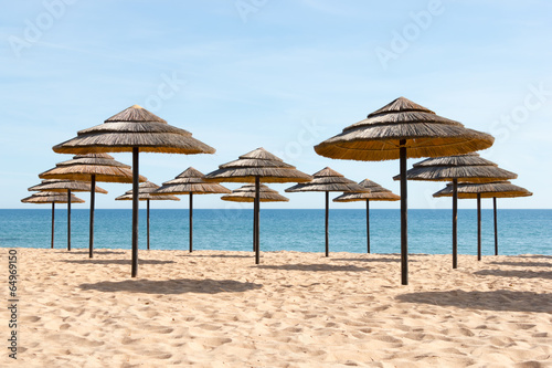 Fototapeta Naklejka Na Ścianę i Meble -  Blue sky, blue sea and parasols at  beach in Portugal