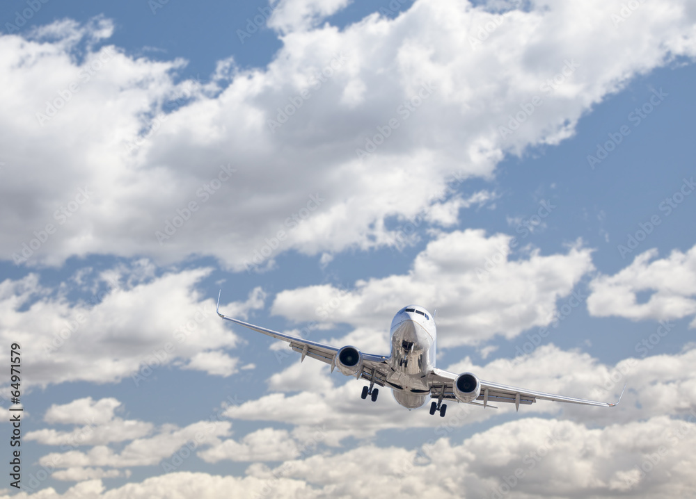 Fototapeta premium Jet Airplane Landing with Dramatic Clouds Behind