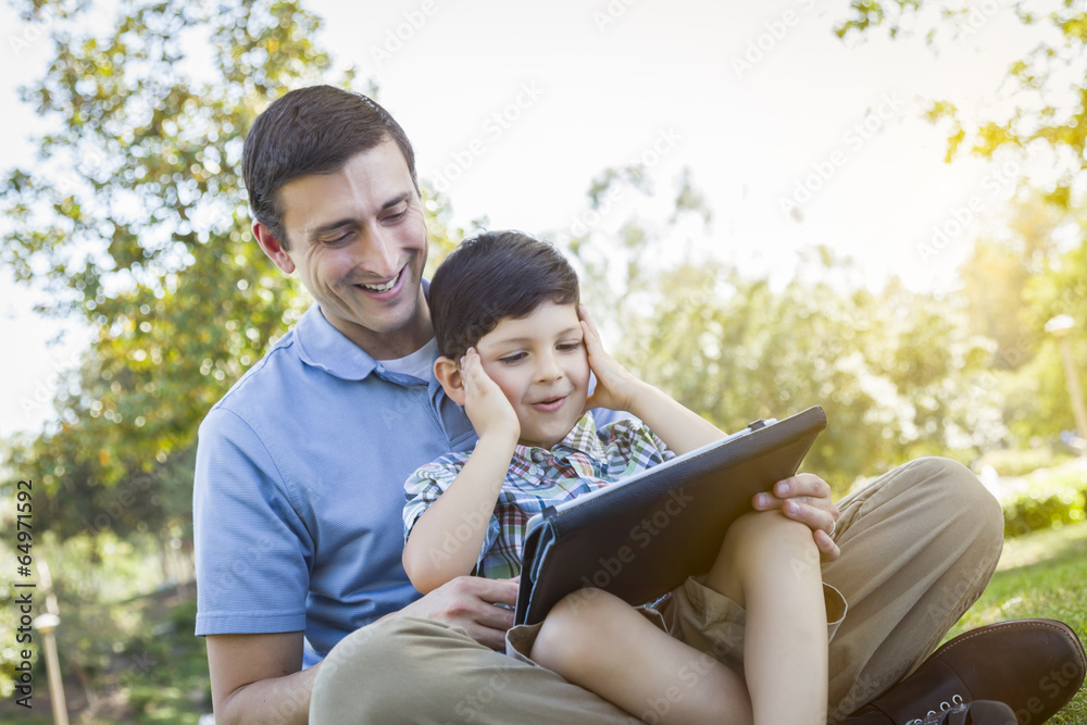 Handsome Mixed Race Father and Son Playing on Computer Tablet Handsome Mixed Race Father and Son Playing on Computer Tablet