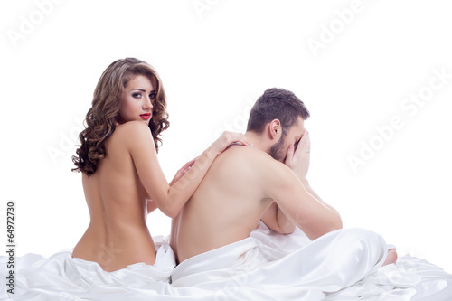 Distressed man with beautiful naked girl in bed