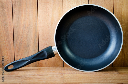 iron frying pan wooden background