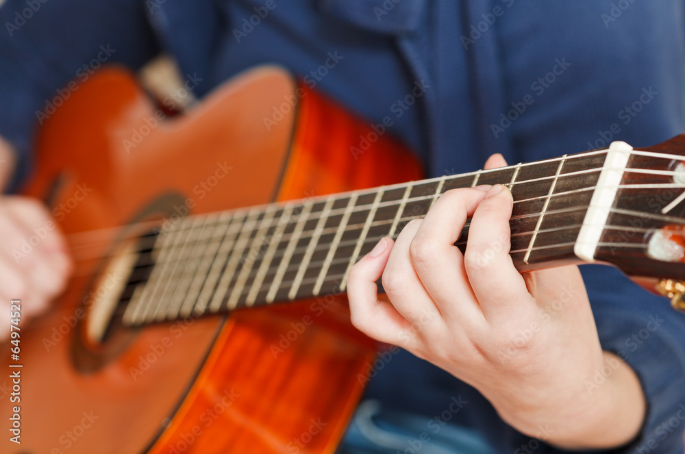 Fototapeta premium girl plays on classical acoustic guitar