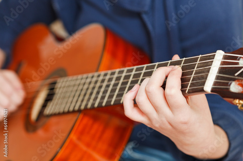girl plays on classical acoustic guitar
