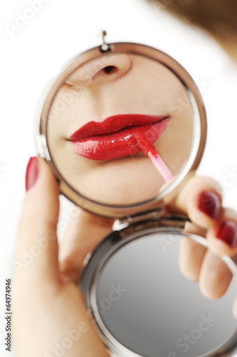 beautiful red lips in a hand mirror