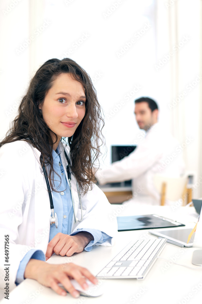 Doctor working at the office assisted with assistant Doctor working at the office assisted with assistant