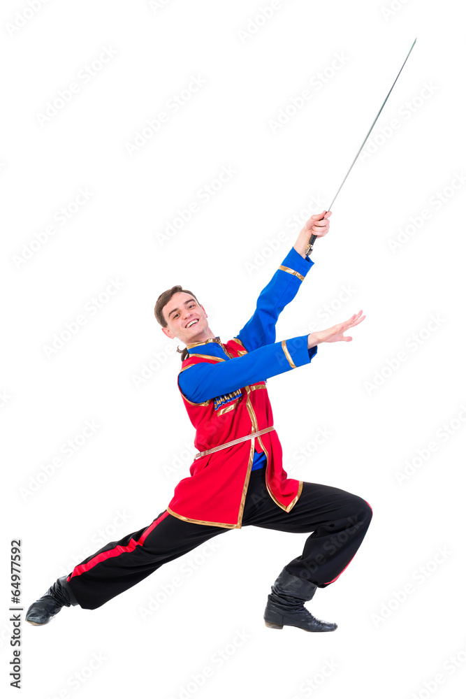 Russian cossack dance. Young dancer posing with sword Russian cossack dance. Young dancer posing with sword