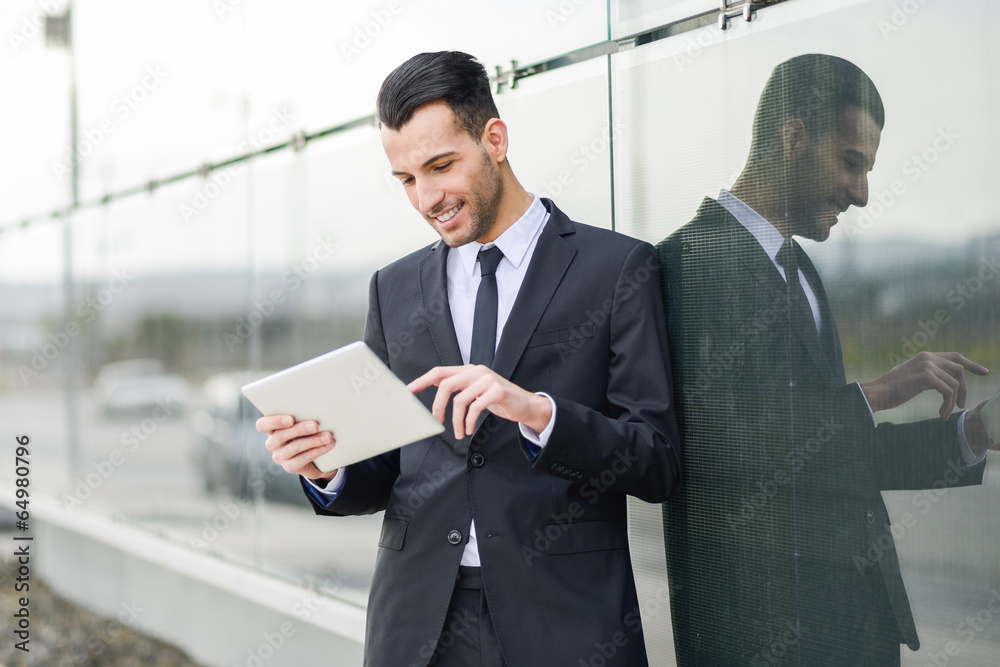 Businessman with tablet computer in office building Businessman with tablet computer in office building