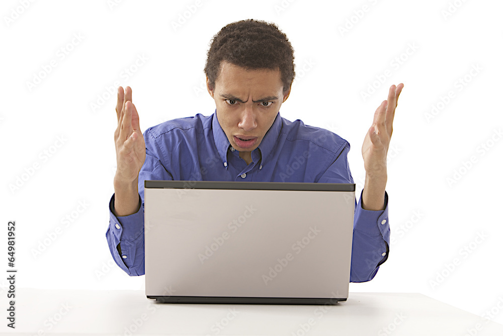 Angry businessman screaming against a laptop Angry businessman screaming against a laptop