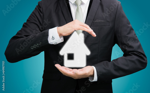 Businessman standing posture hand holding house icon isolated