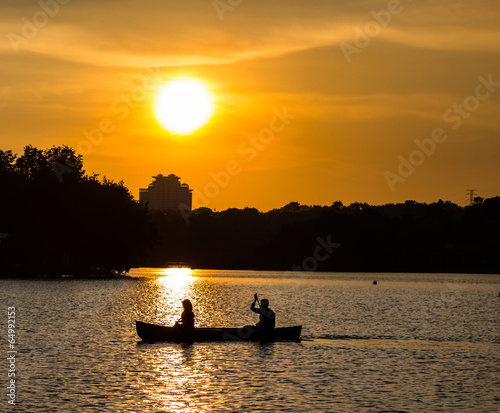 Silhouette of a couple canoeing in a lake, Malaysia photo