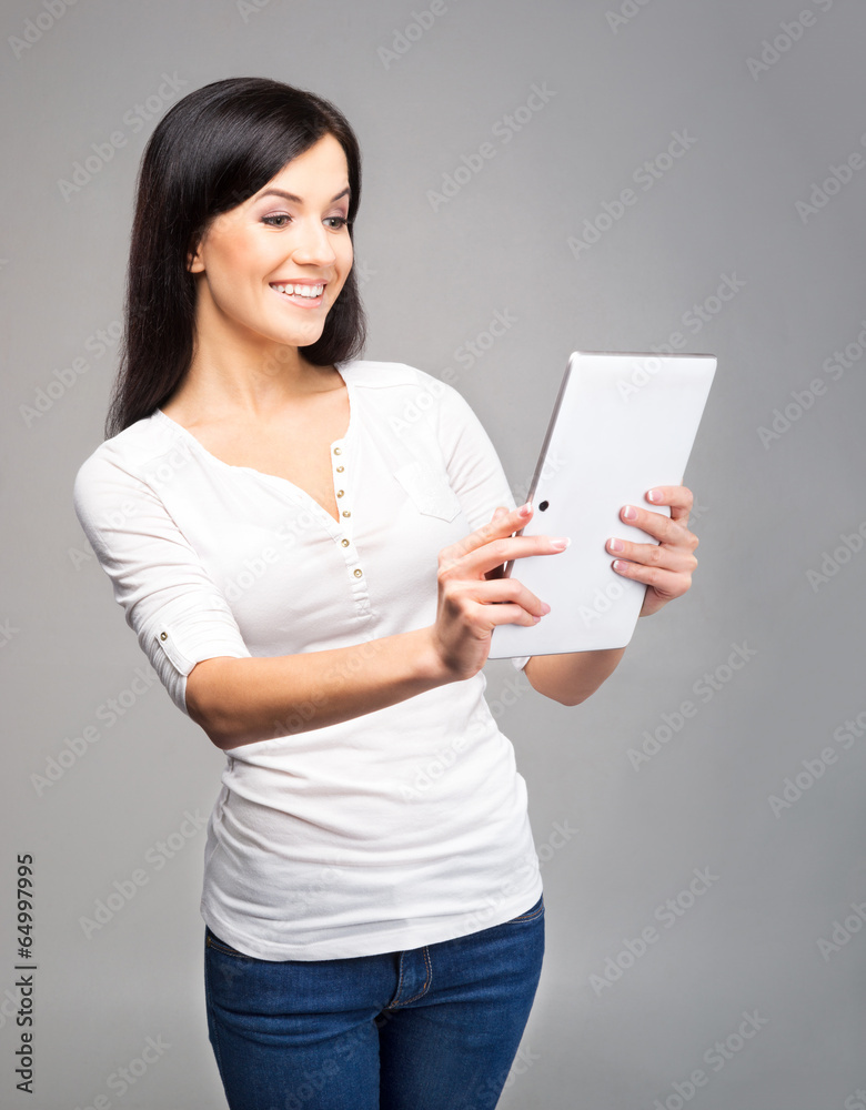 Young and beautiful teenager girl holding an ipad Young and beautiful teenager girl holding an ipad