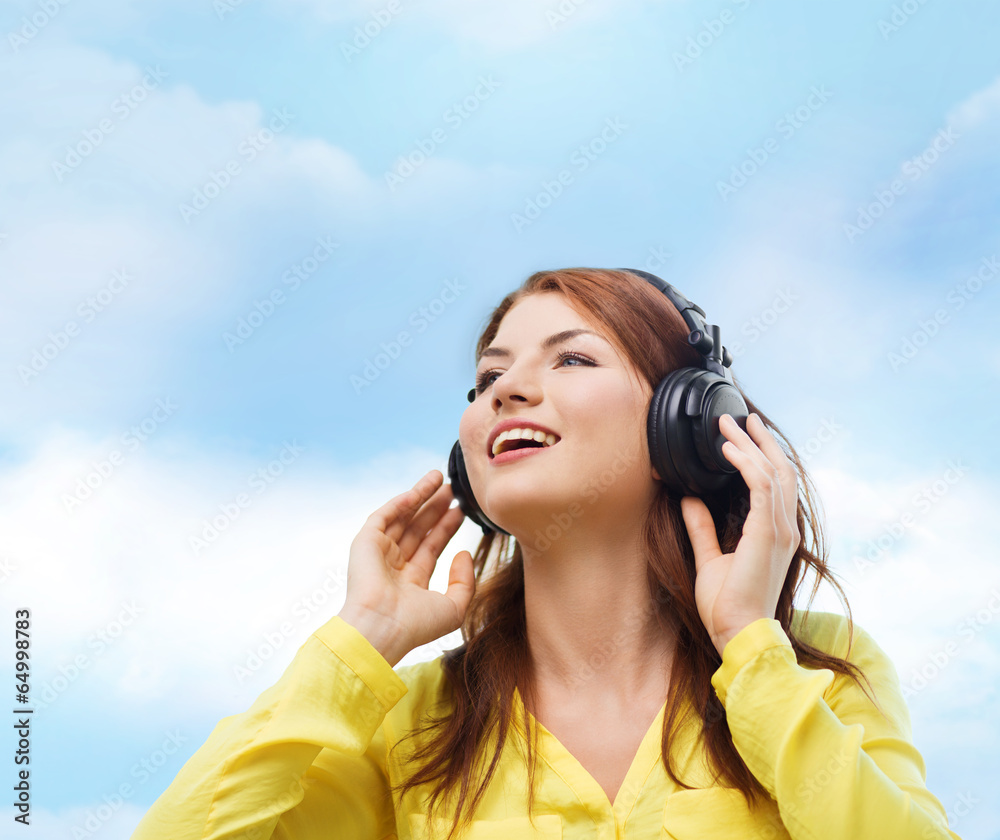 smiling young girl in headphones at home smiling young girl in headphones at home