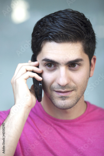 Close up portrait of young man talking on phone