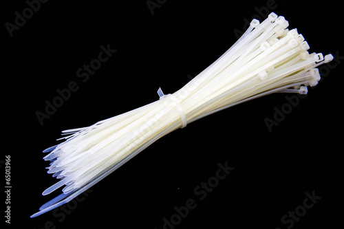 pie of nylon cable ties on black background