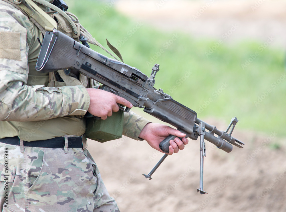 Fototapeta premium soldier with heavy machine gun