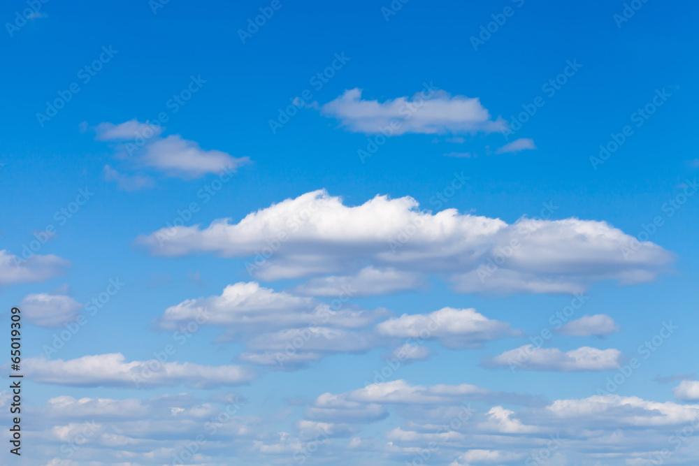 little fluffy white clouds in blue sky