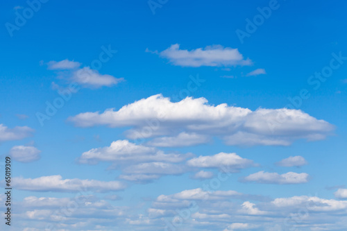 little fluffy white clouds in blue sky