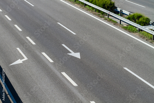 arrows on asphalt showing traffic where to go