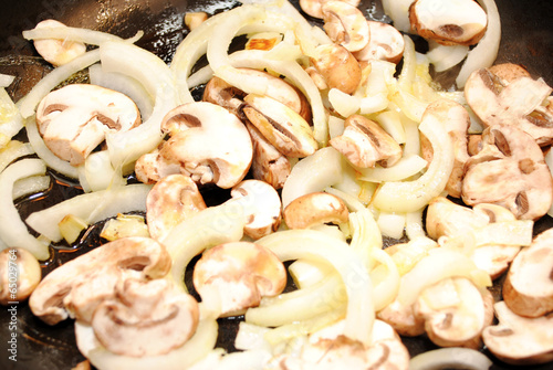 Portabella Mushrooms and Sweet Onions Frying in a Pan