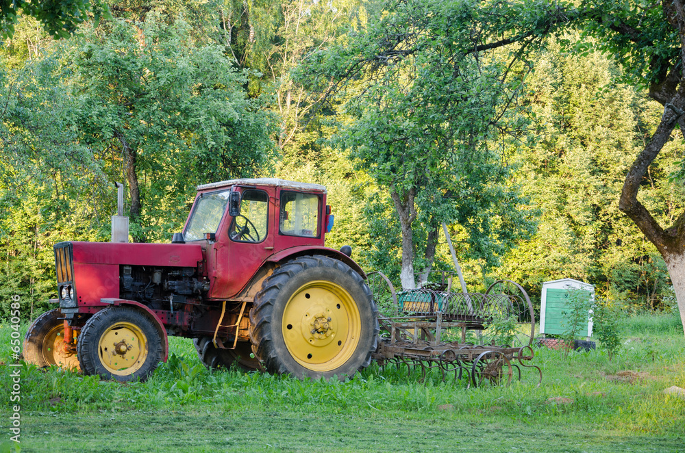 farm tractor with yellow wheels harow in garden farm tractor with yellow wheels harow in garden