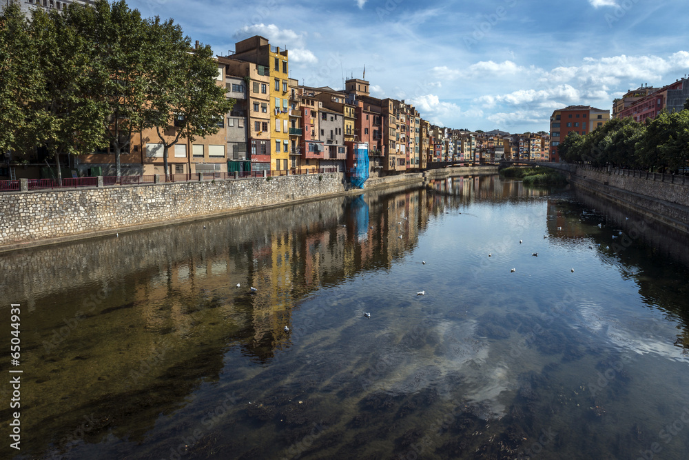 Colorful houses of Girona reflecting in the Onyar River.