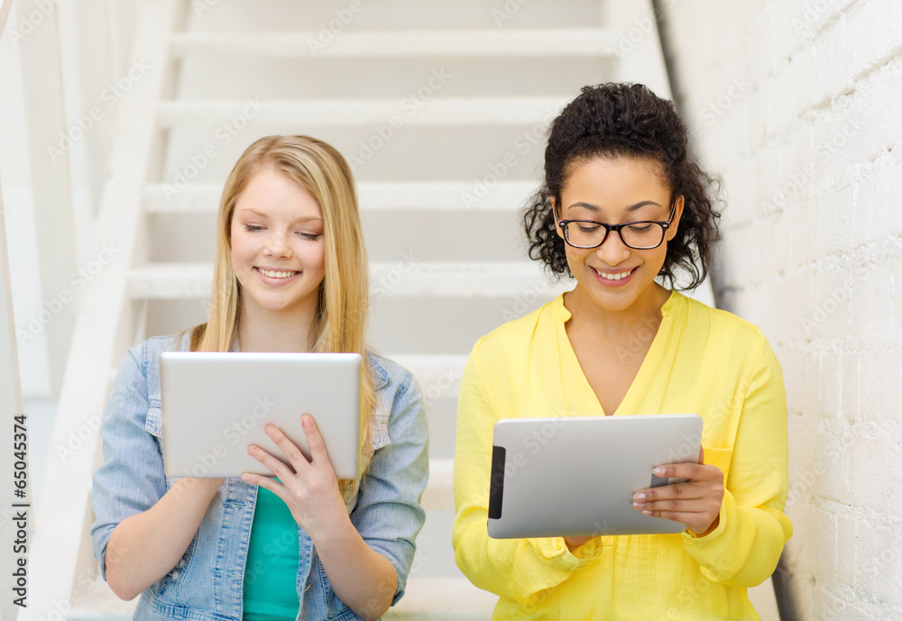 smiling female students with tablet pc computer smiling female students with tablet pc computer