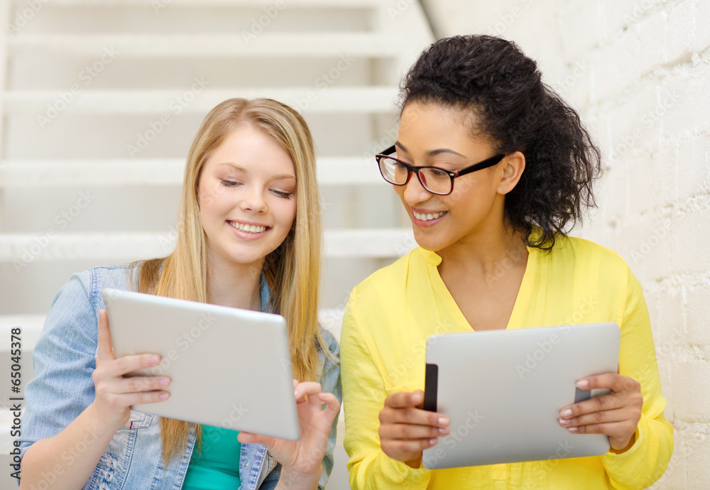 smiling female students with tablet pc computer smiling female students with tablet pc computer