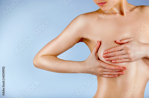 Naklejka Female controlling breast