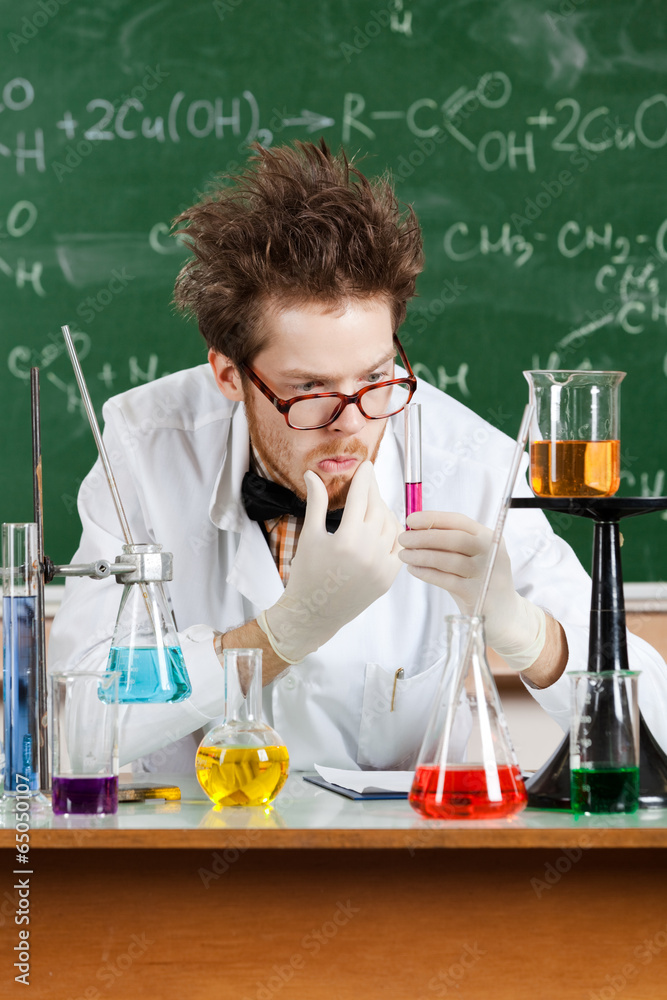 Mad professor thinks about the result of the experiment Stock Photo Mad professor thinks about the result of the experiment Stock Photo