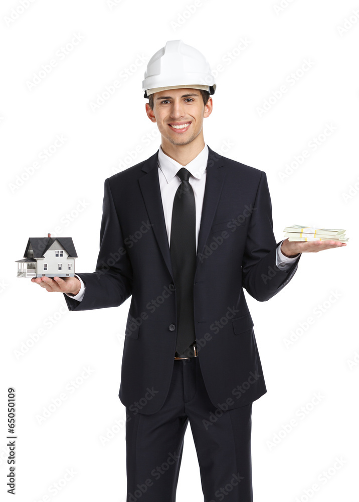 Real estate agent wearing white helmet hands model house Real estate agent wearing white helmet hands model house