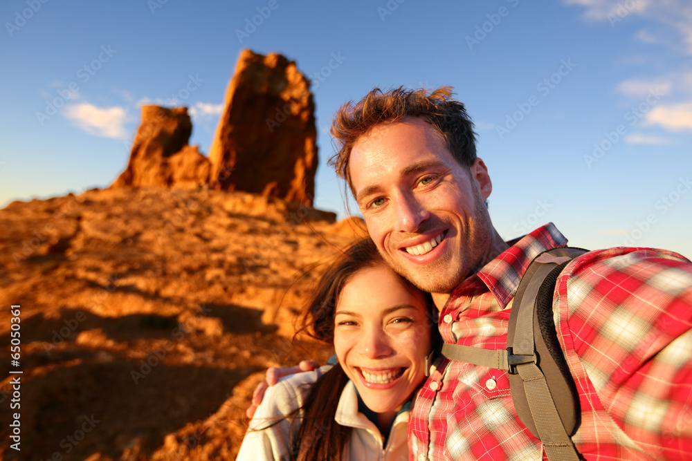 Happy couple taking selfie self portrait hiking