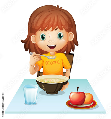 A little girl eating her breakfast