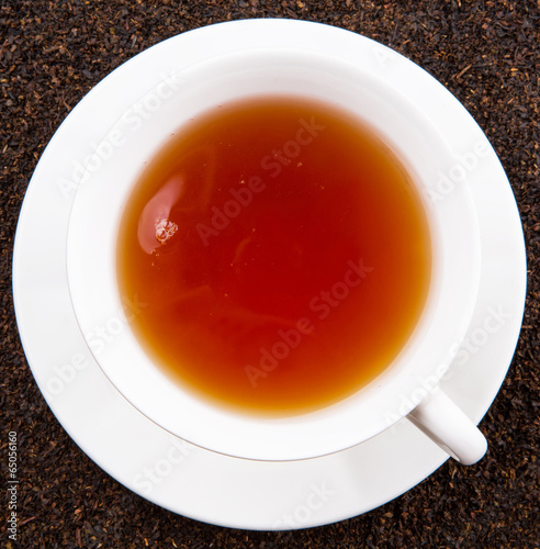 A cup of tea on dried and processed tea leaves