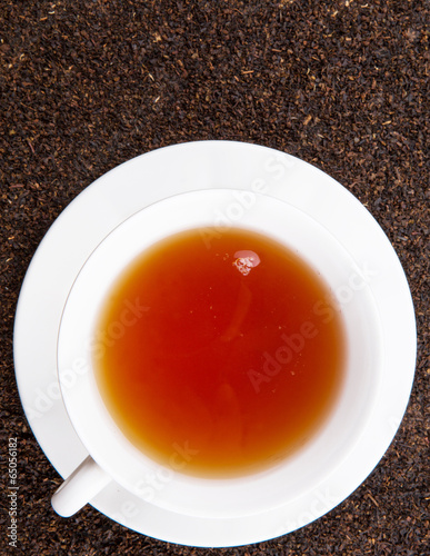 A cup of tea on dried and processed tea leaves