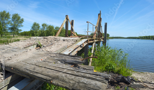 Obsolete bridge on the shore of a lake