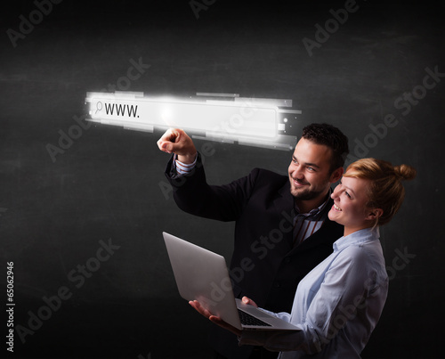 Young business couple touching web browser address bar with www photo