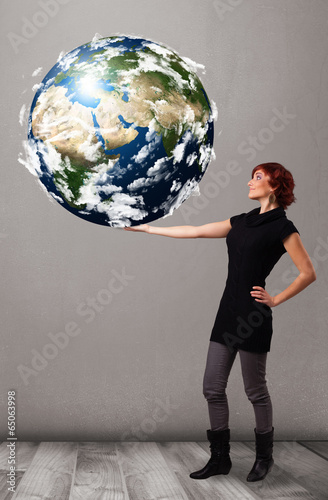 Pretty girl holding 3d planet earth photo