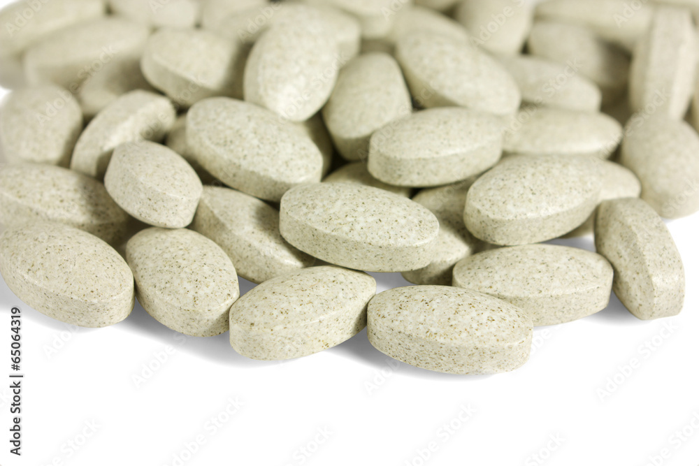Multivitamins oval tablets isolated on white Multivitamins oval tablets isolated on white