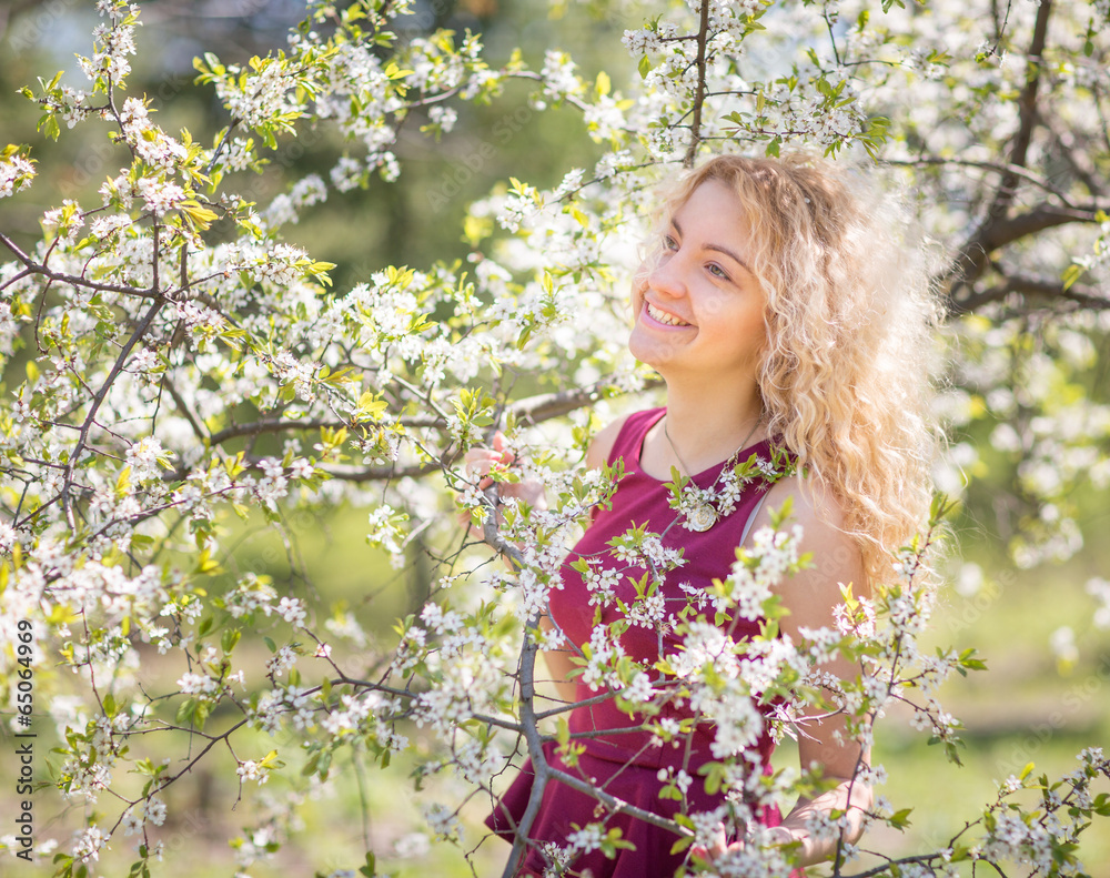 Charming young girl in the spring cherry blossoms Charming young girl in the spring cherry blossoms