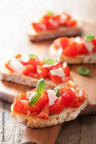 Italian bruschetta with tomatoes, parmesan, garlic and olive oil