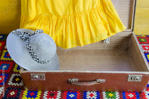 gray femalee hat suitcase yellow dresses fragment photo
