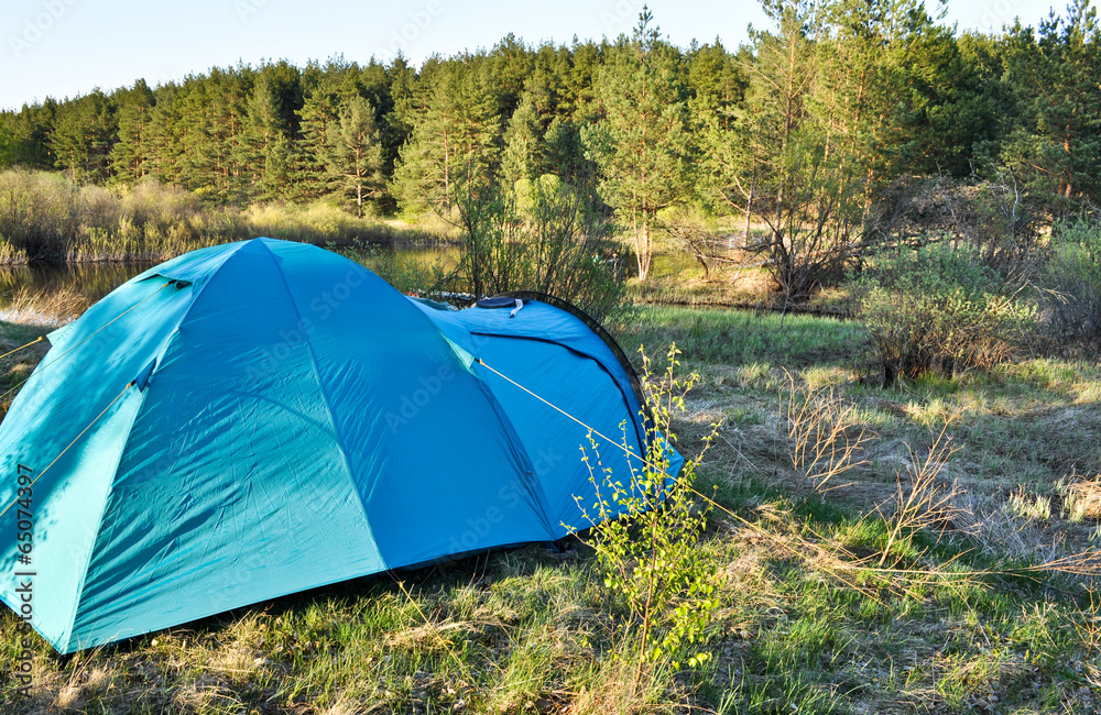 Camping tent on the river Bank.