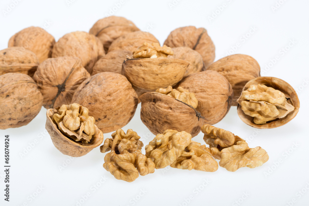 walnut and a cracked walnut isolated on the white background walnut and a cracked walnut isolated on the white background