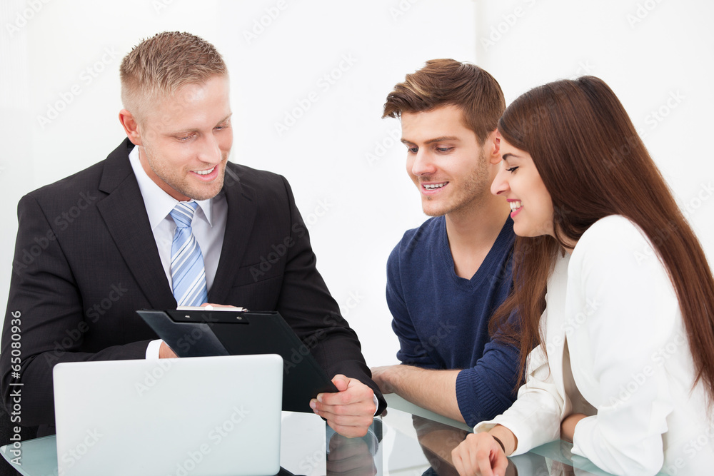 Couple Discussing With Financial Advisor Couple Discussing With Financial Advisor