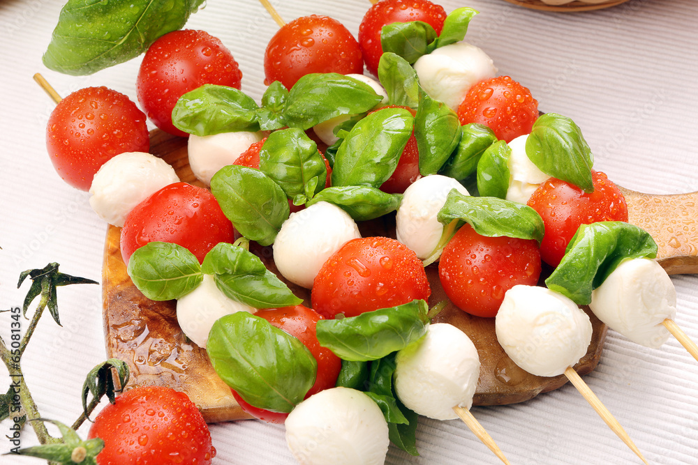 Caprese salad. Skewers with tomato and mozzarella with basil. Caprese salad. Skewers with tomato and mozzarella with basil.