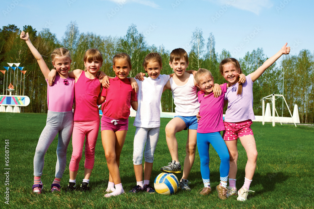 Fototapeta premium Portrait of seven little children with balls
