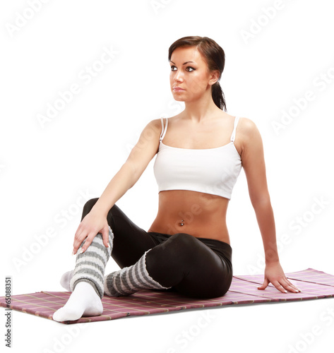A young sportive girl sitting on the floor