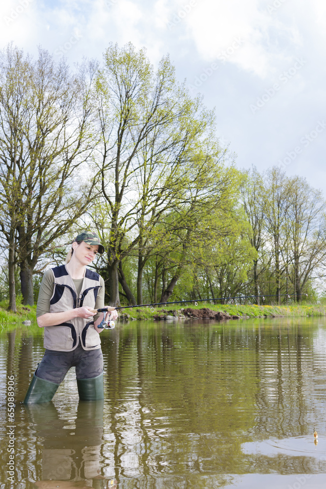 woman fishing in pond in spring woman fishing in pond in spring